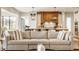 Cozy living room with a comfortable sofa overlooking the kitchen and dining area at 3675 Dartmoor Way, Zionsville, IN 46077