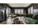 Cozy living room with dark walls, hardwood floors, fireplace, and comfortable seating at 3675 Dartmoor Way, Zionsville, IN 46077
