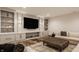 Comfortable living room with custom built-in shelving, a large flat screen television, and stylish decor at 3675 Dartmoor Way, Zionsville, IN 46077