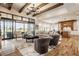 Open-concept living room with hardwood floors and large windows leading to outdoor space at 3675 Dartmoor Way, Zionsville, IN 46077
