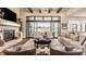 Bright, open living room with fireplace, large sliding glass doors and comfortable seating at 3675 Dartmoor Way, Zionsville, IN 46077