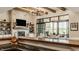 Open living area featuring a fireplace, stone wall, recessed lighting and views of outdoor living space at 3675 Dartmoor Way, Zionsville, IN 46077