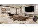 Cozy living room with an inviting sectional sofa, a wet bar, and built-in shelving for stylish storage at 3675 Dartmoor Way, Zionsville, IN 46077