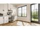 Bright home office features custom built-ins, hardwood floors, a large window, and plenty of natural light at 3675 Dartmoor Way, Zionsville, IN 46077