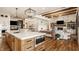 Spacious open-concept kitchen and living room featuring a large island and stone fireplace at 3675 Dartmoor Way, Zionsville, IN 46077
