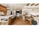 Open-concept kitchen and living room showcasing seamless flow and hardwood floors at 3675 Dartmoor Way, Zionsville, IN 46077