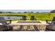 Outdoor seating surrounds a fire pit with serene views of the water, golf course, and community at 3675 Dartmoor Way, Zionsville, IN 46077