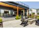 Spacious patio featuring a fire pit, ample seating, and a covered outdoor dining area at 3675 Dartmoor Way, Zionsville, IN 46077