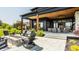 Inviting patio with a stone fire pit, comfortable seating, and a covered outdoor living area at 3675 Dartmoor Way, Zionsville, IN 46077