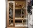 Inviting sauna room with a wood interior and glass door, creating a relaxing wellness space in the home at 3675 Dartmoor Way, Zionsville, IN 46077