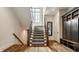 Elegant staircase with carpet runner, wood railing, and a large window for natural light at 3675 Dartmoor Way, Zionsville, IN 46077