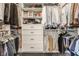 Organized walk-in closet with custom shelving and drawers for ample storage at 3675 Dartmoor Way, Zionsville, IN 46077