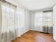 A bedroom with hardwood floors and curtained windows providing plenty of natural light at 4025 Main St, Anderson, IN 46013