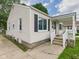 Charming home with white siding and a cozy front porch, perfect for a starter home at 4025 Main St, Anderson, IN 46013