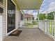 Inviting covered porch with white railings, offering neighborhood views at 4025 Main St, Anderson, IN 46013