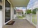 Charming front porch featuring a 'Welcome' mat and a view of the neighbor's house at 4025 Main St, Anderson, IN 46013