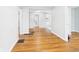 Hallway featuring hardwood floors and neutral walls with open doorways at 4025 Main St, Anderson, IN 46013