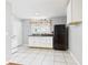 Galley kitchen featuring tile flooring and simple white cabinets at 4025 Main St, Anderson, IN 46013