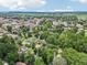 A wide aerial view showcasing a residential area near a town, surrounded by vibrant greenery at 409 N Sycamore St, Martinsville, IN 46151