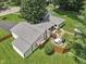 An aerial view of a home's backyard featuring a charming patio and a well-manicured lawn at 409 N Sycamore St, Martinsville, IN 46151