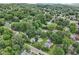 An aerial shot showcasing the neighborhood, highlighting lush greenery and a mix of residential properties at 409 N Sycamore St, Martinsville, IN 46151