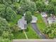Aerial view of a single Gathering home with detached garage, long driveway, and mature trees at 409 N Sycamore St, Martinsville, IN 46151