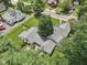 Overhead view of the home nestled among mature trees, showing the roof and surrounding greenery at 409 N Sycamore St, Martinsville, IN 46151
