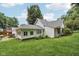 Green backyard featuring exterior views of the home with a covered patio and landscaped yard at 409 N Sycamore St, Martinsville, IN 46151