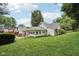 Lush backyard featuring a well-maintained lawn and exterior view of the home at 409 N Sycamore St, Martinsville, IN 46151