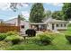 Well-maintained backyard with a patio, grill, picnic table, and a view of the house's exterior at 409 N Sycamore St, Martinsville, IN 46151