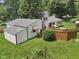 A view of the backyard showcasing the awning covered windows and a fenced-in patio area at 409 N Sycamore St, Martinsville, IN 46151