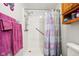 Shower stall with safety bar and hand held shower head, along with patterned shower curtain at 409 N Sycamore St, Martinsville, IN 46151