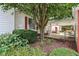 Charming home with a well-manicured garden, a covered area, and mature trees offering shade and beauty at 409 N Sycamore St, Martinsville, IN 46151