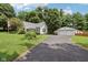 Well-maintained home with long driveway, two-car garage, mature trees and a landscaped front yard at 409 N Sycamore St, Martinsville, IN 46151
