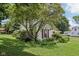 Charming home with mature trees, and well-maintained landscaping, creating a serene and inviting atmosphere at 409 N Sycamore St, Martinsville, IN 46151