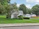 Charming home with red shutters and a well-manicured lawn, complemented by a two car detached garage at 409 N Sycamore St, Martinsville, IN 46151