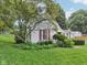 Charming home with red shutters and a tree in the front yard at 409 N Sycamore St, Martinsville, IN 46151