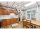 Bright eat-in kitchen with wood cabinets, a ceiling fan, and light wood-style flooring at 409 N Sycamore St, Martinsville, IN 46151