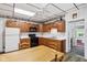 Bright eat-in kitchen with oak cabinets and wood-look flooring at 409 N Sycamore St, Martinsville, IN 46151