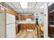 View of eat-in kitchen with oak cabinets, white appliances, and wood-look floors at 409 N Sycamore St, Martinsville, IN 46151