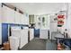 Well-lit laundry room with appliances, storage cabinets, and a utility sink at 409 N Sycamore St, Martinsville, IN 46151