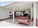 Inviting covered patio with a porch swing, perfect for relaxing and enjoying the outdoors at 409 N Sycamore St, Martinsville, IN 46151
