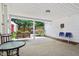 Covered patio featuring comfortable seating, including a swing, and a view of the well-maintained backyard at 409 N Sycamore St, Martinsville, IN 46151