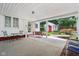 Spacious covered patio featuring outdoor seating and a view of the charming backyard with a red shed at 409 N Sycamore St, Martinsville, IN 46151