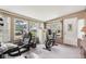 Bright multi-purpose sun room with home office and exercise bike at 409 N Sycamore St, Martinsville, IN 46151