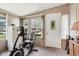 Sun room with an exercise bike, tile floor and access to the back yard at 409 N Sycamore St, Martinsville, IN 46151