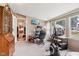 Multi-purpose sun room featuring a home office area and exercise equipment at 409 N Sycamore St, Martinsville, IN 46151