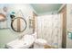 Charming bathroom featuring a stylish vanity, decorative mirror, and themed shower curtain at 4210 Main St, Anderson, IN 46013