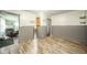 Bedroom boasts wood floors, natural light, wainscoting, and access to other living spaces at 4210 Main St, Anderson, IN 46013