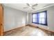 This bedroom features neutral paint, wood flooring, natural light, and a ceiling fan at 4210 Main St, Anderson, IN 46013